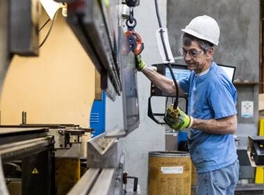 A factory worker manufacturing products on an assembly line.